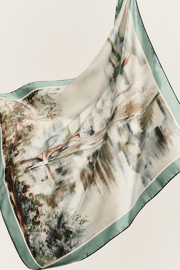 Detail shot of the Max Mara Sartoriale Oversized Scarf in light blue printed silk, with fringed trim on the edges.